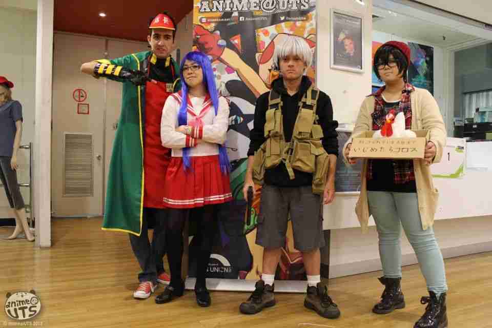 Old photo of cosplaying club members in front of a banner